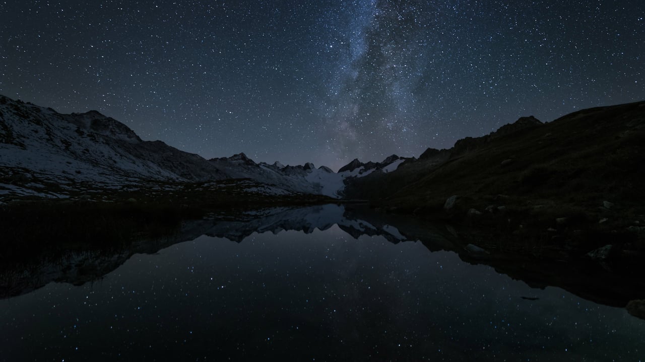Stars reflected in the Totensee, a mountain lake at Grimsel Pass, Switzerland (© magodevita/Getty Images) desktop wallpaper