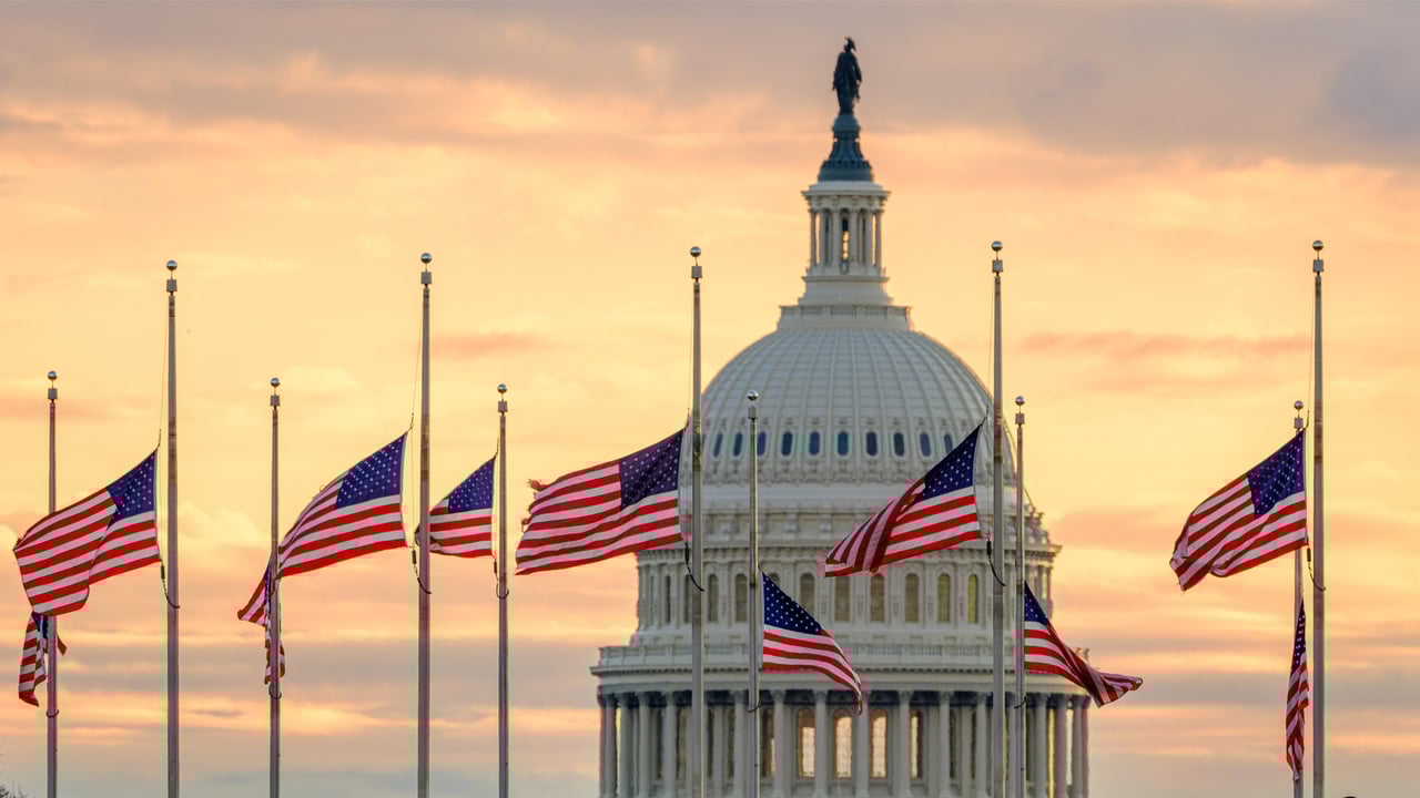 The US Capitol dome with flags flying at half-staff in honor of former President Jimmy Carter, Washington, DC (© J. David Ake/Getty Images) desktop wallpaper
