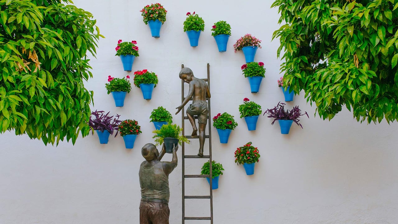 Bronze sculpture of a child and his grandfather caring for plants and flowers in the San Basilio neighborhood of Córdoba, Spain (© David M G/Alamy) desktop wallpaper