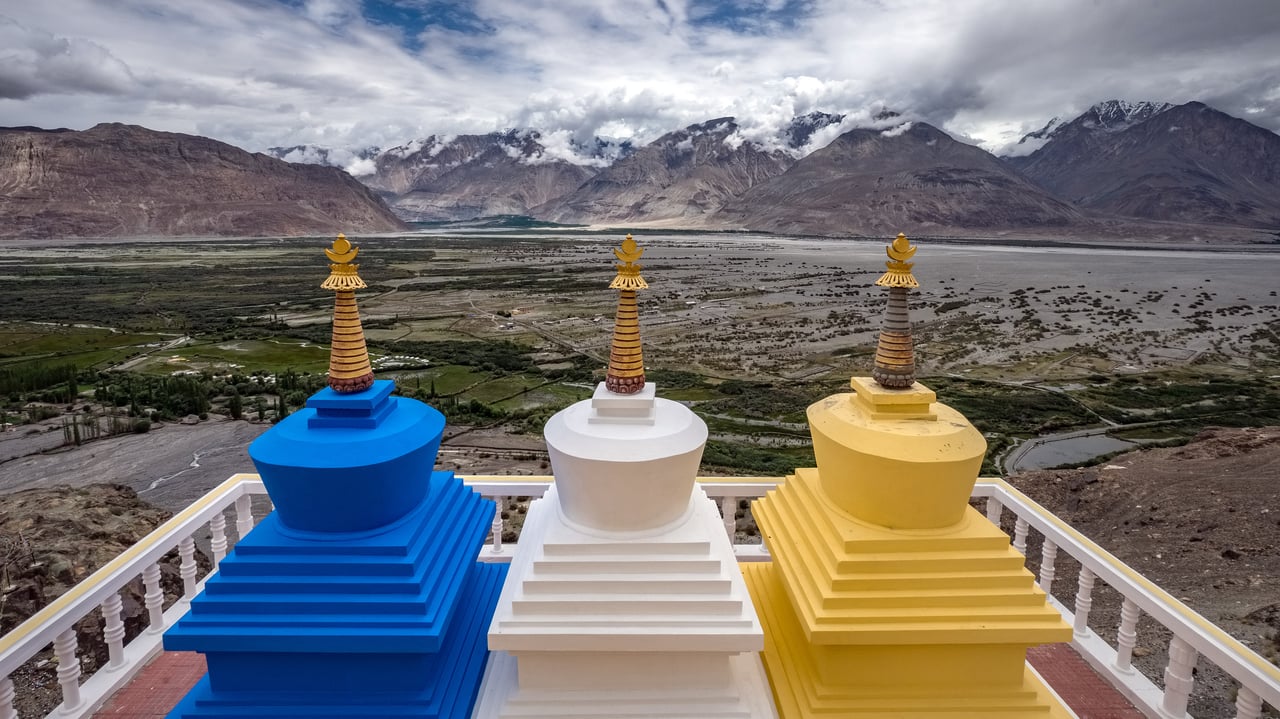 Three stupa with Nubra Valley in the background in Ladakh, India (© Puripat Lertpunyaroj/Getty Images) desktop wallpaper