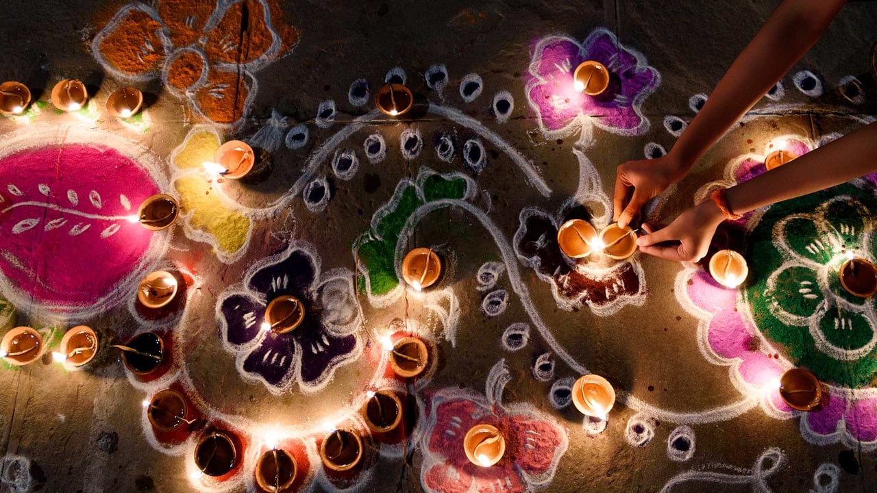 Oil lamps being arranged on rangoli designs during Diwali (© Subir Basak/Getty Images) desktop wallpaper