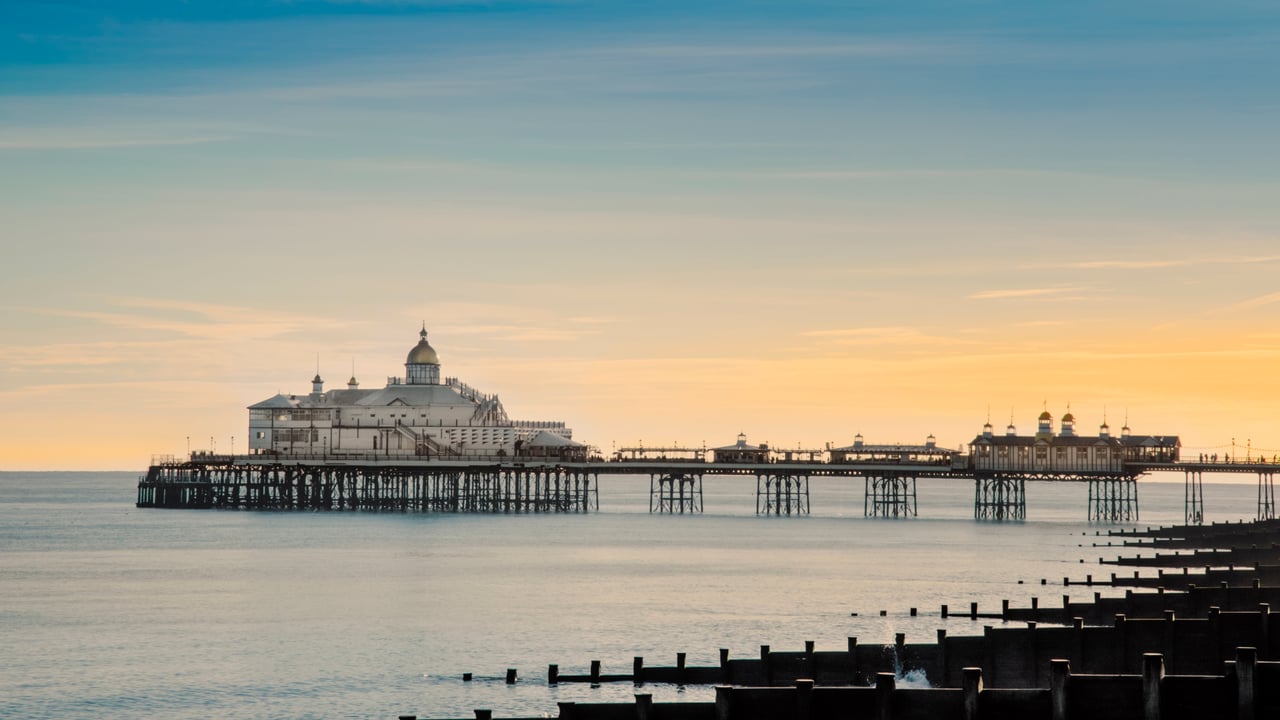 View along the beach to Eastbourne Pier, Eastbourne, East Sussex. (© Robert Harding World Imagery/Offset by Shutterstock) desktop wallpaper