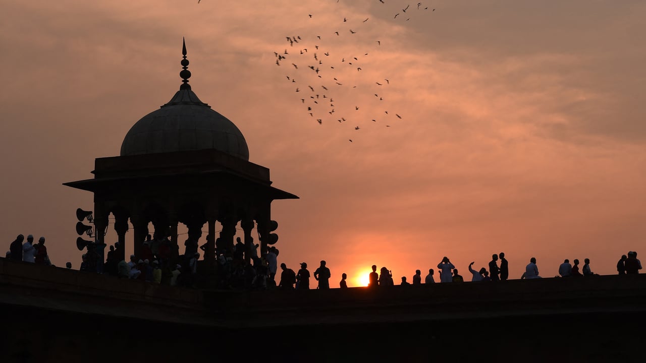 Muslims gather to offer prayers during Eid al-Fitr at Jama Masjid in New Delhi (© MONEY SHARMA/Getty Images) desktop wallpaper