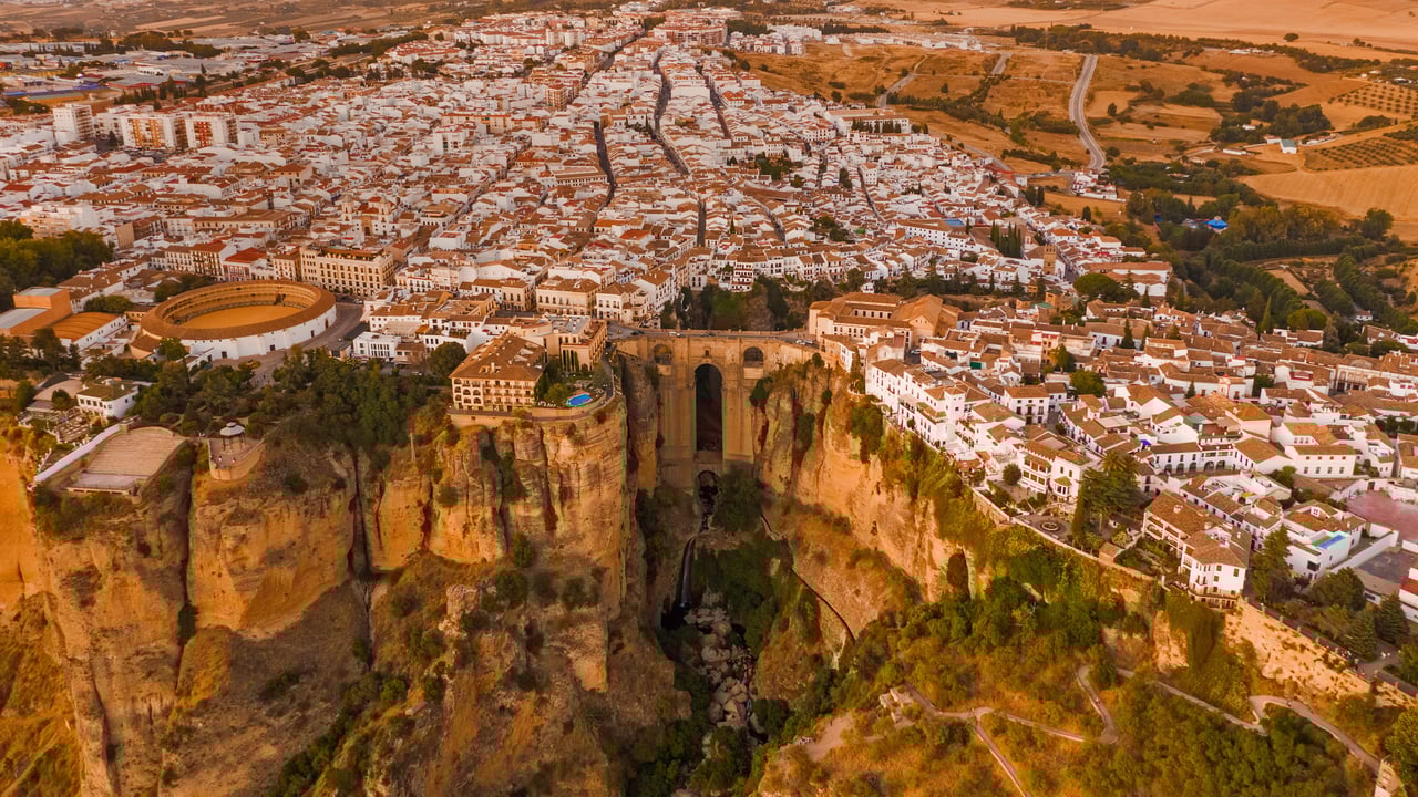 Aerial view of El Tajo gorge and the Puente Nuevo bridge in Ronda, Málaga, Spain (© Jude Newkirk/Amazing Aerial Agency) desktop wallpaper