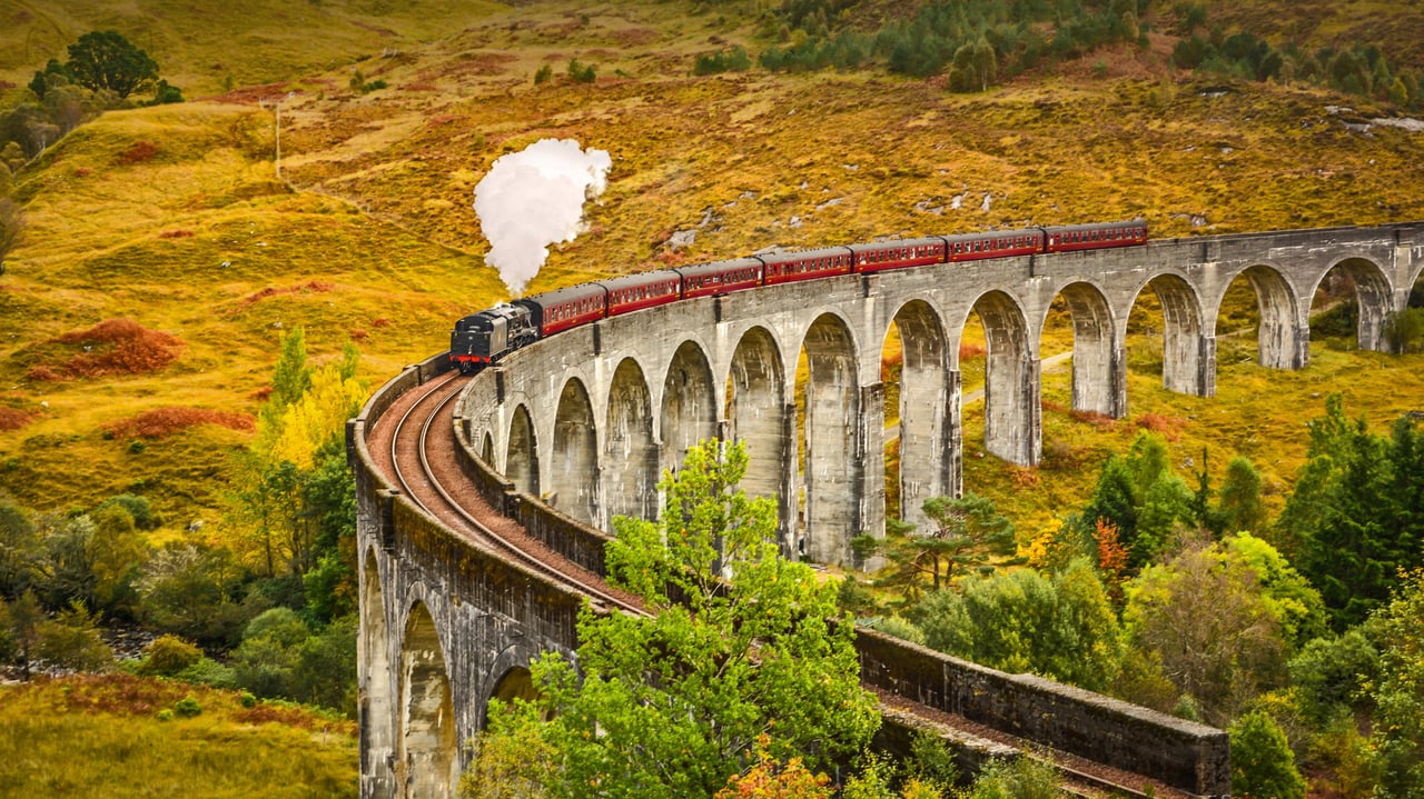 The Jacobite steam train crossing the Glenfinnan Viaduct in Inverness-shire, Scotland (© The Escape of Malee/Shutterstock) desktop wallpaper