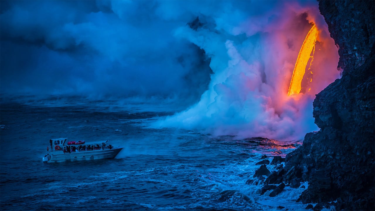 A lava flow hits water as a tour boat passes, Hawaii Volcanoes National Park (© Patrick Kelley/Getty Images) desktop wallpaper