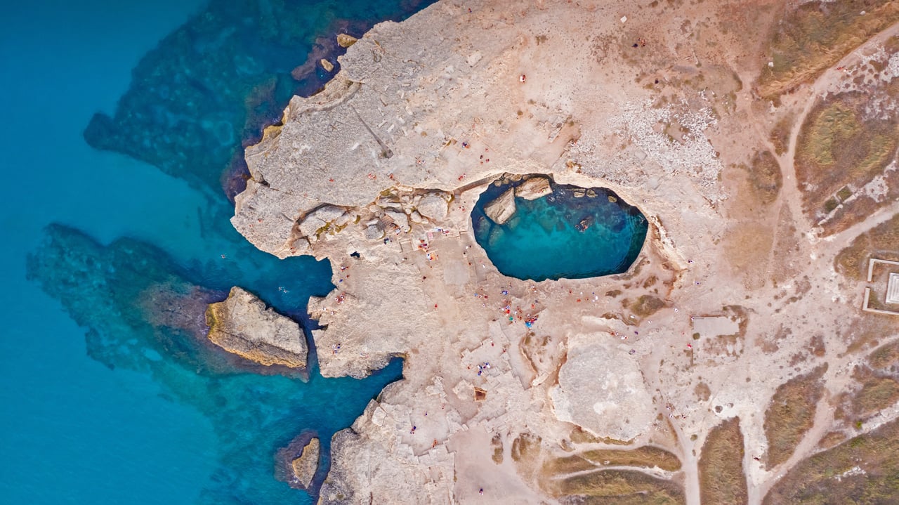 Aerial view of the Grotta della Poesia (Poetry's Cave) near Roca, Lecce, Italy (© Amazing Aerial Agency/Offset by Shutterstock) desktop wallpaper