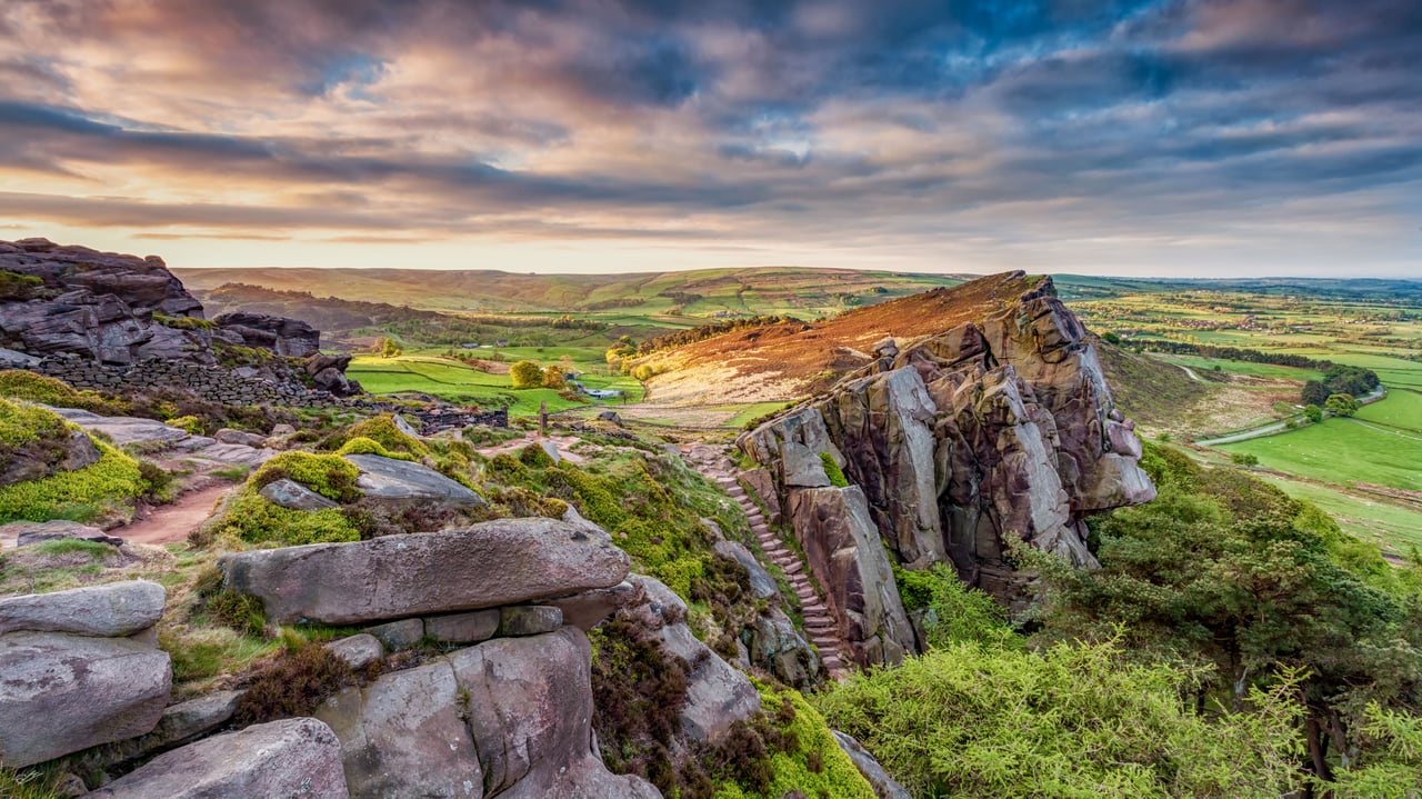 View of the rocky gritstone edge of The Roaches looking over the patchwork landscape, Peak District, Staffordshire. (© George W Johnson/Getty Images) desktop wallpaper