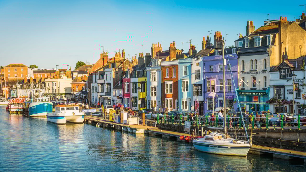 Colourful cottages, fishing boats and yachts around the harbour in Weymouth, Dorset (© fotoVoyager/Getty Images) desktop wallpaper