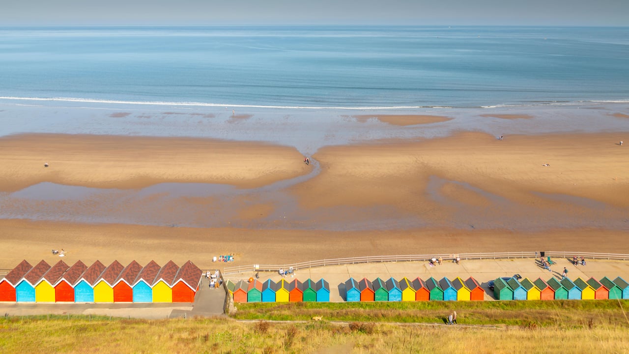 Beach huts on West Cliff Beach, Whitby, North Yorkshire (© Robert Harding World Imagery/Offset) desktop wallpaper