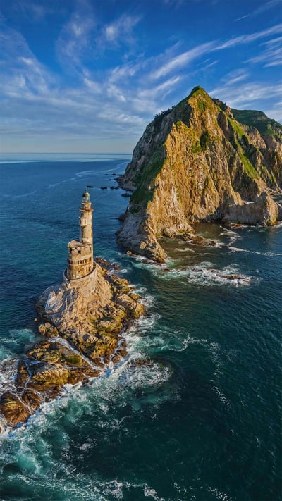 Lighthouse at Cape Aniva, Sakhalin Island, Russia (© Amazing Aerial Agency/Offset by Shutterstock) mobile wallpaper