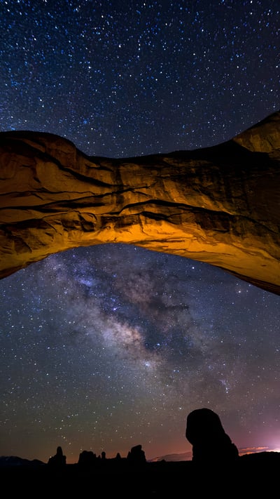 The Milky Way framed by Double Arch in Arches National Park, Utah (© Adventure_Photo/Getty Images) mobile wallpaper