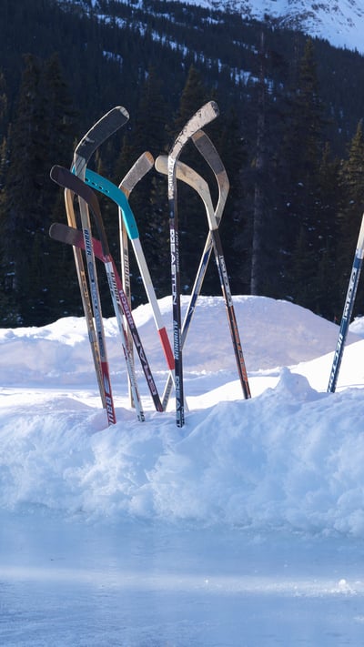 Ice hockey sticks in snow, Banff, Alta. (© Ascent/PKS Media Inc./Getty Images) mobile wallpaper
