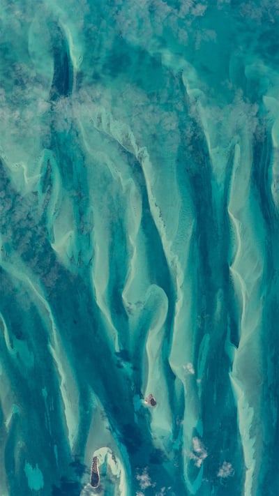 Blue-green waters around the Bahamas as seen from the International Space Station (© NASA) mobile wallpaper