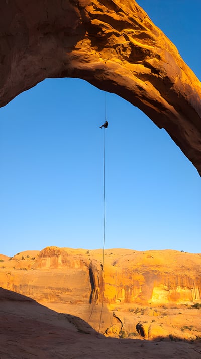 A man rappels off Corona Arch near Moab, Utah (© Grant Ordelheide/TANDEM Stills + Motion) mobile wallpaper