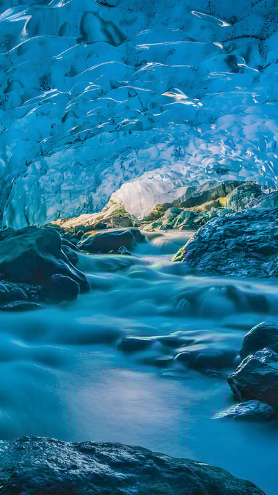 Flowing river inside a glacier cave, Vatnajökull, Iceland (© Marco Bottigelli/Getty Images) mobile wallpaper