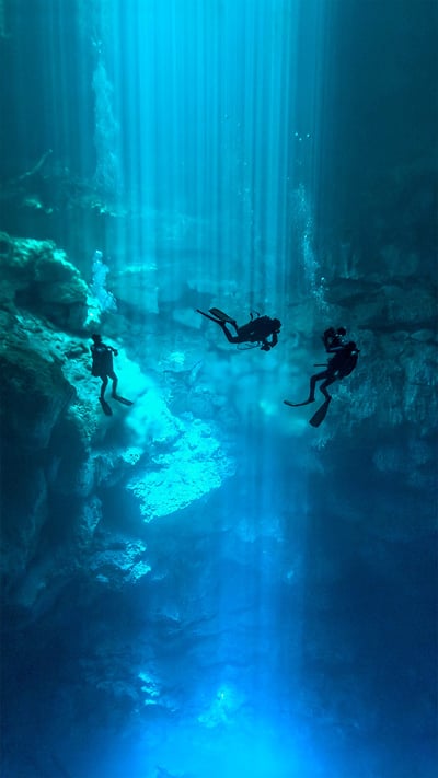 Divers at El Pit Cenote, located in Dos Ojos Natural Park, Quintana Roo, Mexico (© Christia Vizl/Tandem Stills + Motion) mobile wallpaper