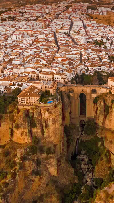 Aerial view of El Tajo gorge and the Puente Nuevo bridge in Ronda, Málaga, Spain (© Jude Newkirk/Amazing Aerial Agency) mobile wallpaper