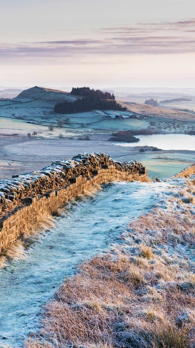 Frosty morning at Hadrian's Wall on Winshields Crags, looking towards Crag Lough in Northumberland (© Nigel Eve/Shutterstock) mobile wallpaper