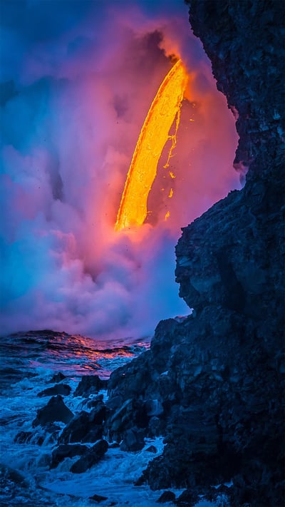 A lava flow hits water as a tour boat passes, Hawaii Volcanoes National Park (© Patrick Kelley/Getty Images) mobile wallpaper