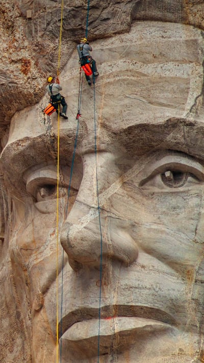 Park service employees inspecting Mount Rushmore National Memorial, South Dakota (© Universal Images Group via Getty Images) mobile wallpaper