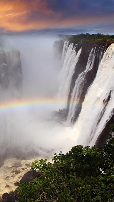 Rainbow at Victoria Falls in Zambia (© Dietmar Temps/Shutterstock) mobile wallpaper