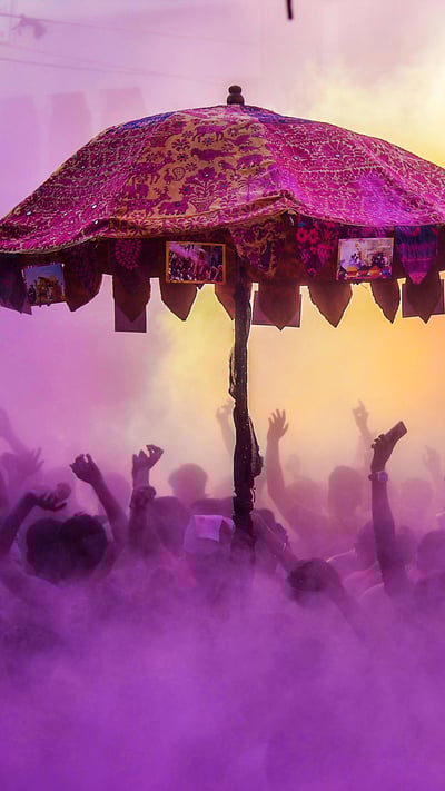 Devotees and foreign tourists partaking in 'kapda-phaar' during Holi celebrations. (© SHAUKAT AHMED/AFP/Getty Images) mobile wallpaper