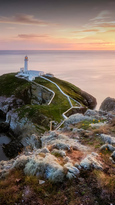 South Stack Lighthouse at sunset, Holy Island, Wales (© mariotlr/Getty Images) mobile wallpaper