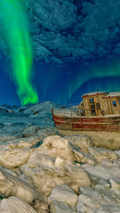 Northern lights over a stranded boat in Tasiilaq, Greenland (© Shane P. White/Minden Pictures) mobile wallpaper