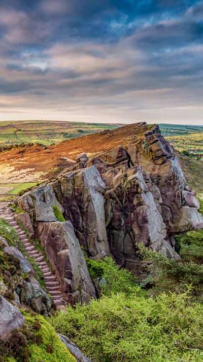 View of the rocky gritstone edge of The Roaches looking over the patchwork landscape, Peak District, Staffordshire. (© George W Johnson/Getty Images) mobile wallpaper