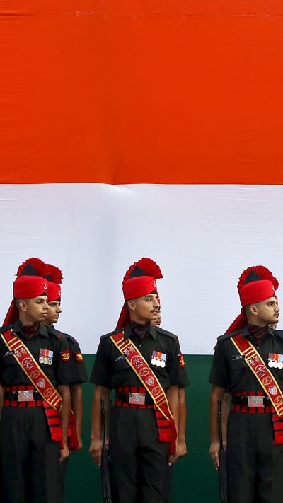 Soldiers stand guard in front of a tricolour flag rehearsal (© Adnan Abidi/Reuters) mobile wallpaper