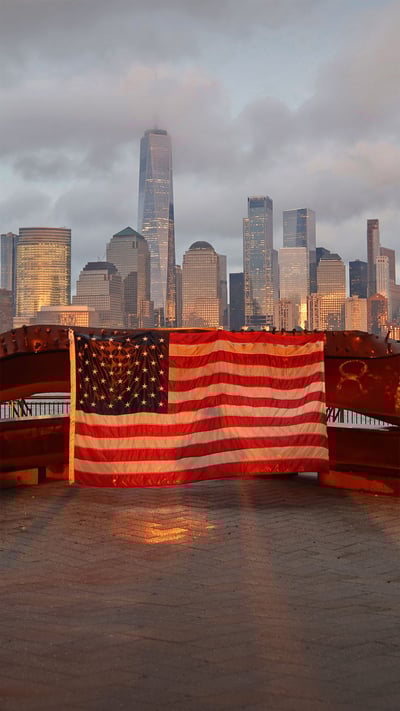 US flag on part of a 9/11 memorial overlooking the New York skyline from Exchange Place, Jersey City, New Jersey (© Gary Hershorn/Getty Images) mobile wallpaper