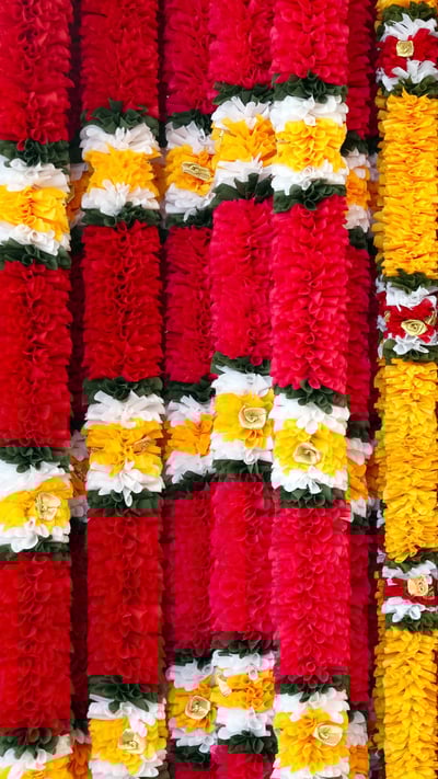 Garlands of red and yellow flowers, on Ugadi (© Sviridenko/iStock/Getty Images Plus) mobile wallpaper