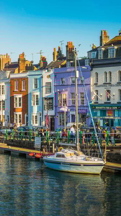 Colourful cottages, fishing boats and yachts around the harbour in Weymouth, Dorset (© fotoVoyager/Getty Images) mobile wallpaper