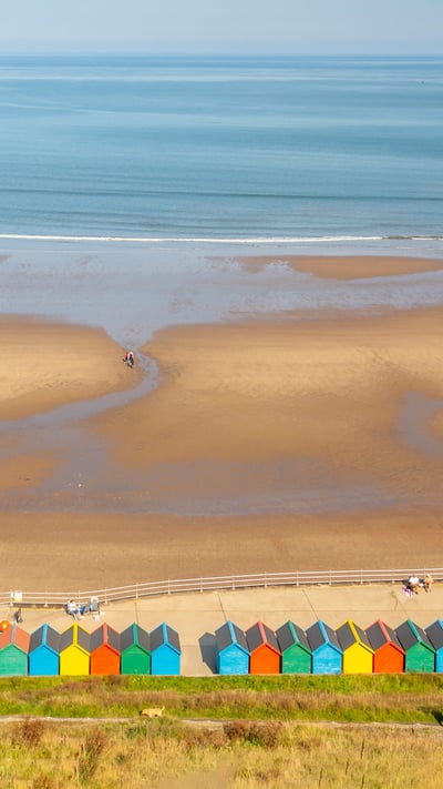 Beach huts on West Cliff Beach, Whitby, North Yorkshire (© Robert Harding World Imagery/Offset) mobile wallpaper
